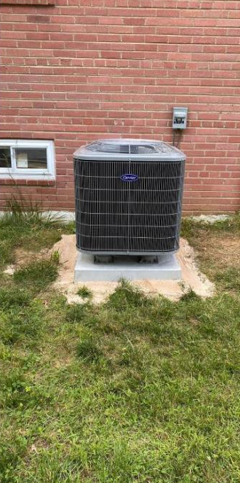 New energy-efficient AC condenser installed on a fresh level pad